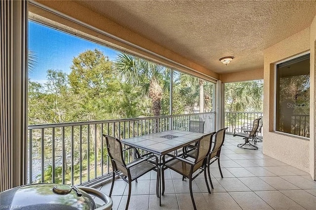 13091 Sandy Key Bnd Unit 104, North Fort Myers, FL 33903 - sunroom / solarium with a textured ceiling and tile patterned floors