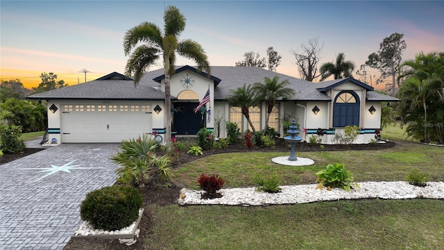 13703 Drysdale Ave, Port Charlotte, FL 33981 - ranch-style house with stucco siding, decorative driveway, a garage, and a yard