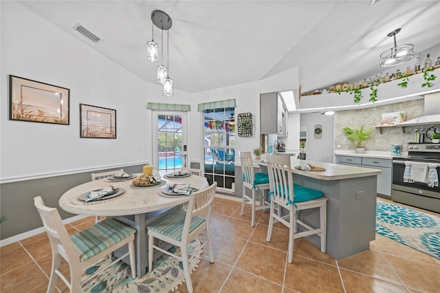 13703 Drysdale Ave, Port Charlotte, FL 33981 - dining area with vaulted ceiling and light tile patterned flooring