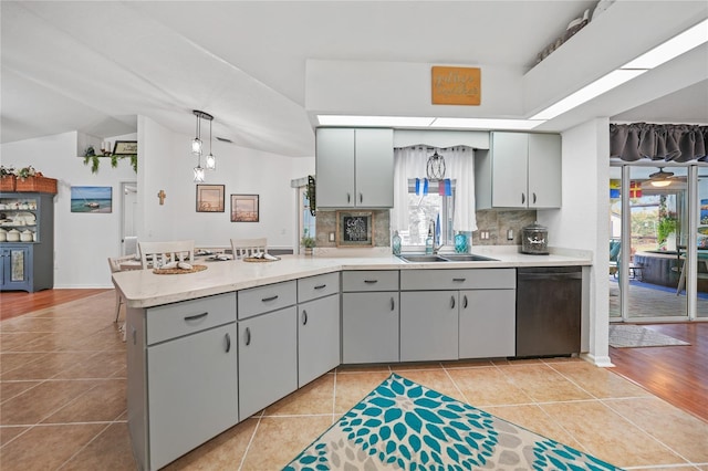13703 Drysdale Ave, Port Charlotte, FL 33981 - kitchen with dishwasher, light tile patterned floors, gray cabinets, a peninsula, and lofted ceiling