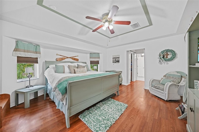 13703 Drysdale Ave, Port Charlotte, FL 33981 - bedroom with a raised ceiling, light wood-style flooring, and ceiling fan