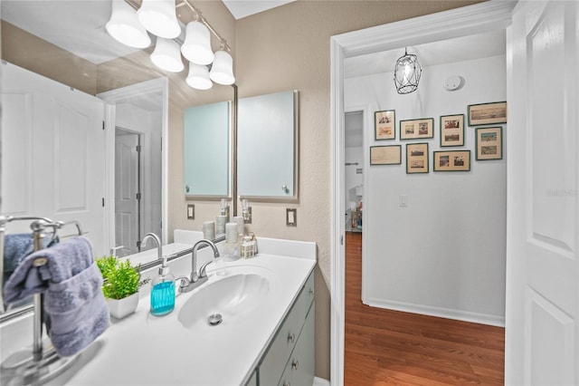 13703 Drysdale Ave, Port Charlotte, FL 33981 - bathroom featuring vanity, wood finished floors, baseboards, and a chandelier