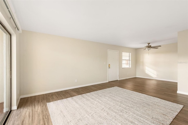 96 Boundary Blvd Unit 112, Rotonda West, FL 33947 - unfurnished living room featuring wood finished floors, baseboards, and ceiling fan