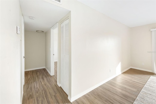 96 Boundary Blvd Unit 112, Rotonda West, FL 33947 - corridor featuring wood finished floors and baseboards