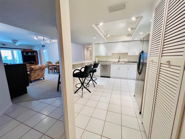 2380 N Beach Rd Unit 210, Englewood, FL 34223 - kitchen featuring stainless steel dishwasher, a sink, light tile patterned flooring, open floor plan, and rail lighting