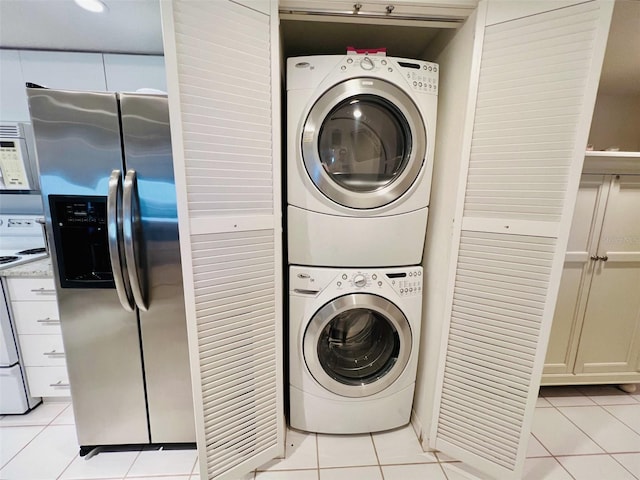 2380 N Beach Rd Unit 210, Englewood, FL 34223 - laundry area with stacked washing machine and dryer and light tile patterned floors