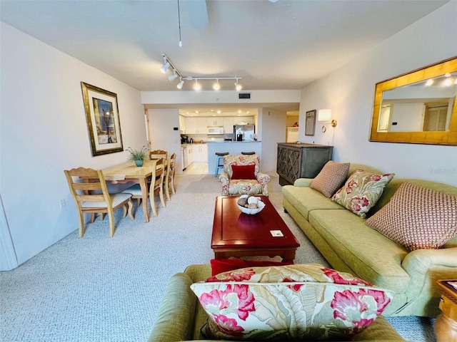 2380 N Beach Rd Unit 210, Englewood, FL 34223 - living room featuring light colored carpet and rail lighting