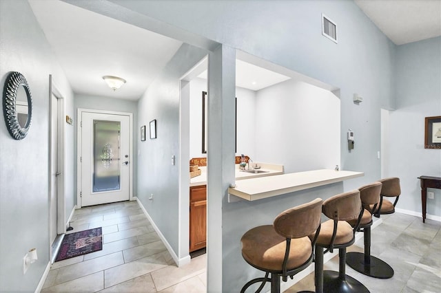 534 Wekiva River Ct Unit 103, Englewood, FL 34223 - foyer with light tile patterned flooring and baseboards