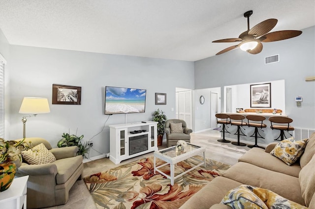 534 Wekiva River Ct Unit 103, Englewood, FL 34223 - living room with ceiling fan, high vaulted ceiling, and baseboards