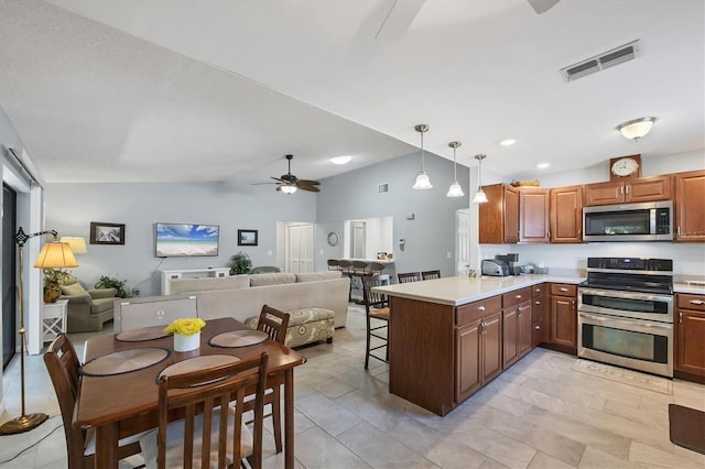 534 Wekiva River Ct Unit 103, Englewood, FL 34223 - kitchen with appliances with stainless steel finishes, ceiling fan, a peninsula, open floor plan, and light countertops