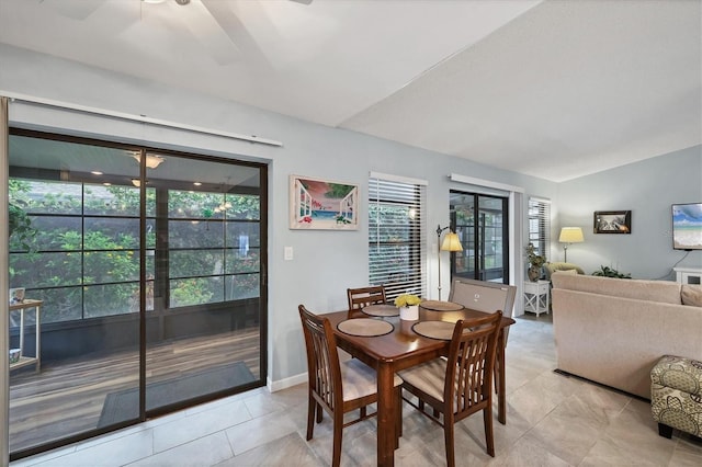 534 Wekiva River Ct Unit 103, Englewood, FL 34223 - dining area featuring a ceiling fan, vaulted ceiling, and light tile patterned floors