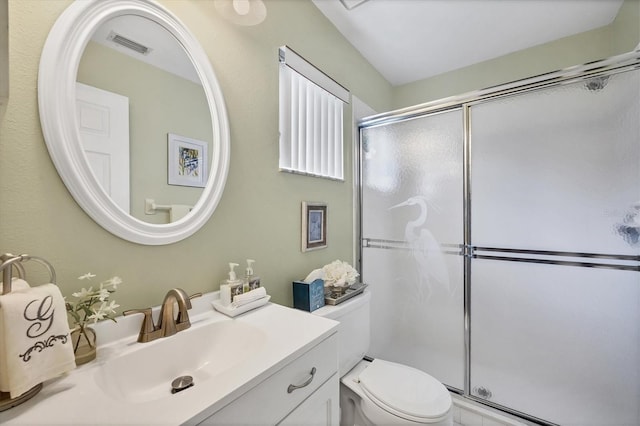 534 Wekiva River Ct Unit 103, Englewood, FL 34223 - bathroom featuring a shower with shower door, toilet, and vanity