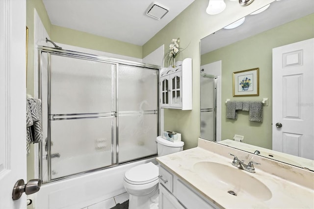 534 Wekiva River Ct Unit 103, Englewood, FL 34223 - full bathroom featuring vanity, toilet, shower / bath combination with glass door, and tile patterned flooring