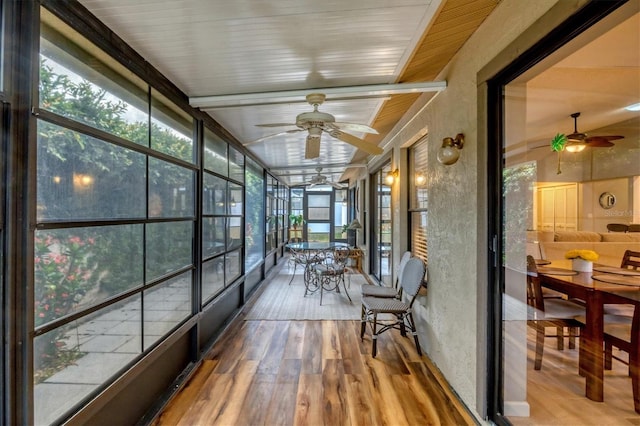 534 Wekiva River Ct Unit 103, Englewood, FL 34223 - sunroom featuring ceiling fan, wood finished floors, a wall of windows, and beamed ceiling