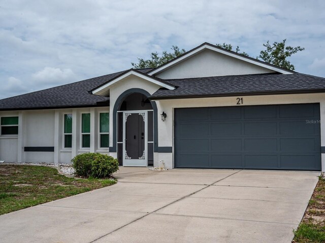 21 Sportsman Way, Rotonda West, FL 33947 - ranch-style house featuring stucco siding, driveway, an attached garage, and roof with shingles