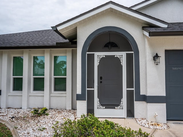 21 Sportsman Way, Rotonda West, FL 33947 - property entrance with stucco siding and a shingled roof