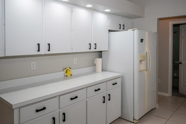 21 Sportsman Way, Rotonda West, FL 33947 - kitchen featuring white refrigerator with ice dispenser, light tile patterned floors, light countertops, white cabinets, and recessed lighting