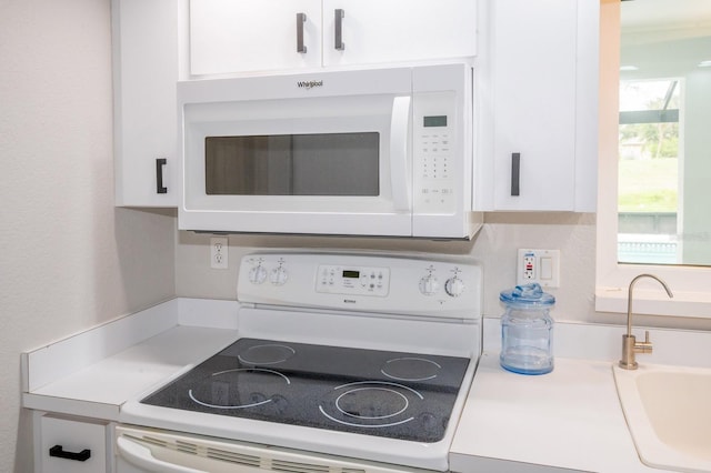 21 Sportsman Way, Rotonda West, FL 33947 - kitchen with white appliances, a sink, white cabinetry, and light countertops