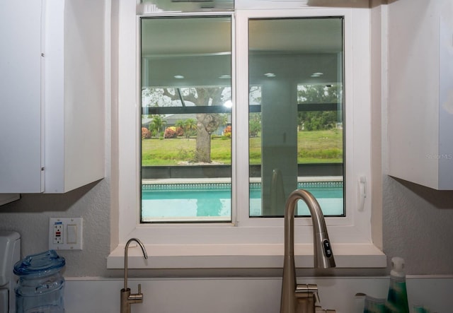 21 Sportsman Way, Rotonda West, FL 33947 - interior space featuring a textured wall, plenty of natural light, and white cabinetry