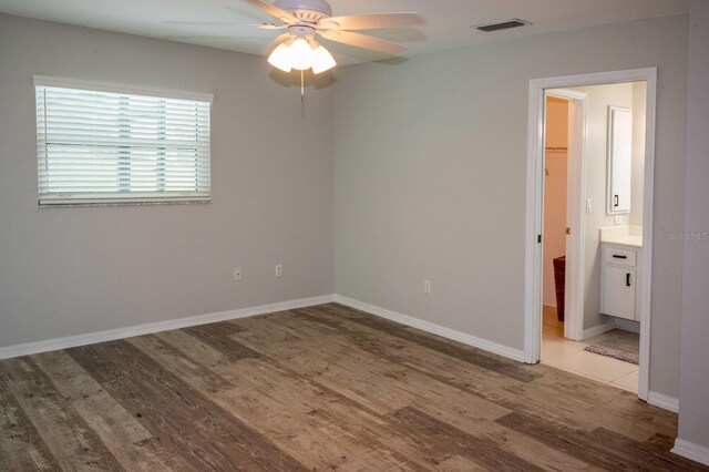 21 Sportsman Way, Rotonda West, FL 33947 - spare room with light wood finished floors, a ceiling fan, and baseboards