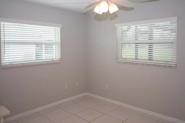 21 Sportsman Way, Rotonda West, FL 33947 - spare room with healthy amount of natural light, ceiling fan, baseboards, and light tile patterned floors