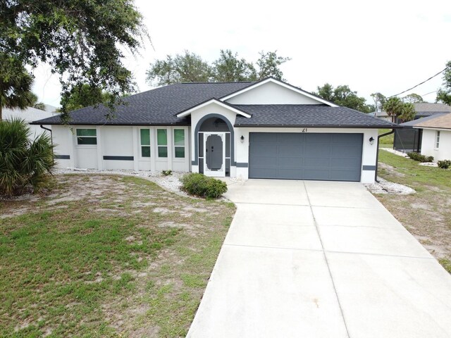 21 Sportsman Way, Rotonda West, FL 33947 - ranch-style home with an attached garage, driveway, roof with shingles, stucco siding, and a front yard