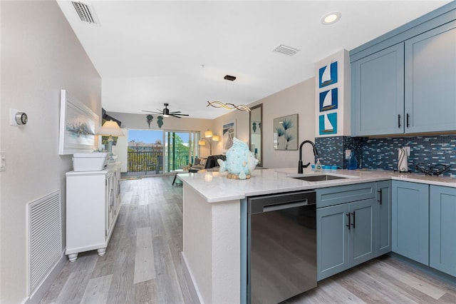 8405 Placida Rd Unit 406, Placida, FL 33946 - kitchen featuring dishwasher, a sink, light wood finished floors, a ceiling fan, and a peninsula