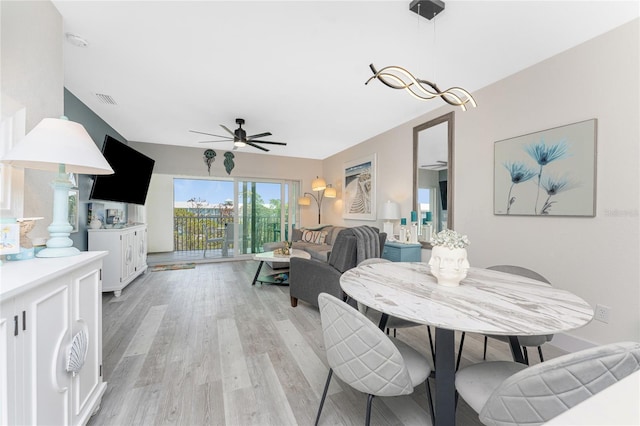 8405 Placida Rd Unit 406, Placida, FL 33946 - dining space with ceiling fan and light wood finished floors