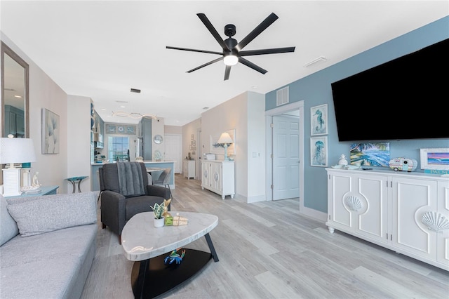 8405 Placida Rd Unit 406, Placida, FL 33946 - living room with ceiling fan, light wood finished floors, and baseboards