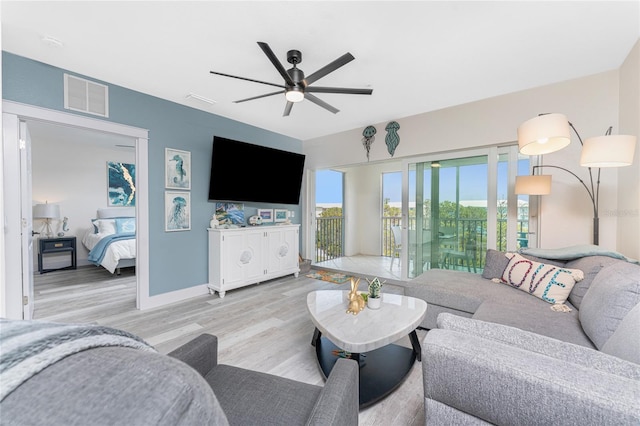 8405 Placida Rd Unit 406, Placida, FL 33946 - living area featuring ceiling fan, wood finished floors, and baseboards