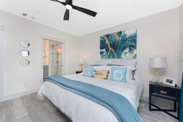 8405 Placida Rd Unit 406, Placida, FL 33946 - bedroom featuring wood finished floors, ensuite bathroom, a ceiling fan, and baseboards