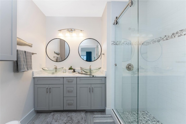 8405 Placida Rd Unit 406, Placida, FL 33946 - full bathroom featuring a stall shower, double vanity, and baseboards