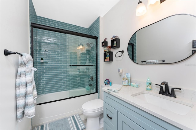 8405 Placida Rd Unit 406, Placida, FL 33946 - bathroom with vanity, shower / bath combination with glass door, and toilet
