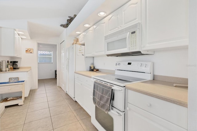 423 Boundary Blvd, Rotonda West, FL 33947 - kitchen featuring white appliances, white cabinetry, light tile patterned floors, light countertops, and recessed lighting