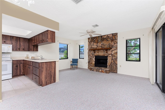 1337 Le Pera Rd, Englewood, FL 34223 - kitchen with white appliances, light countertops, a sink, open floor plan, and ceiling fan