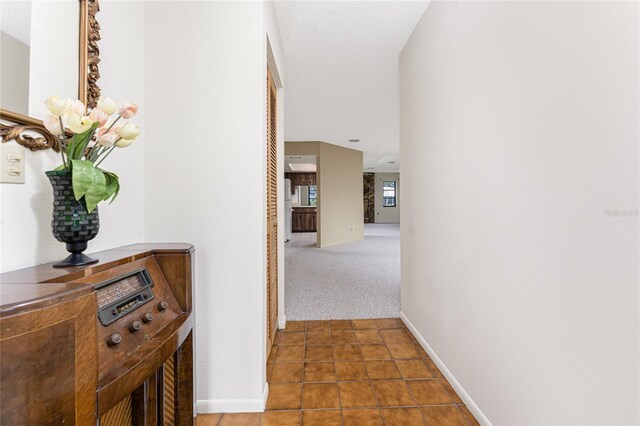 1337 Le Pera Rd, Englewood, FL 34223 - corridor featuring baseboards, tile patterned flooring, and carpet