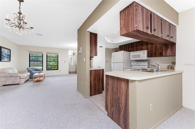 1337 Le Pera Rd, Englewood, FL 34223 - kitchen featuring white appliances, light colored carpet, light countertops, a chandelier, and open floor plan