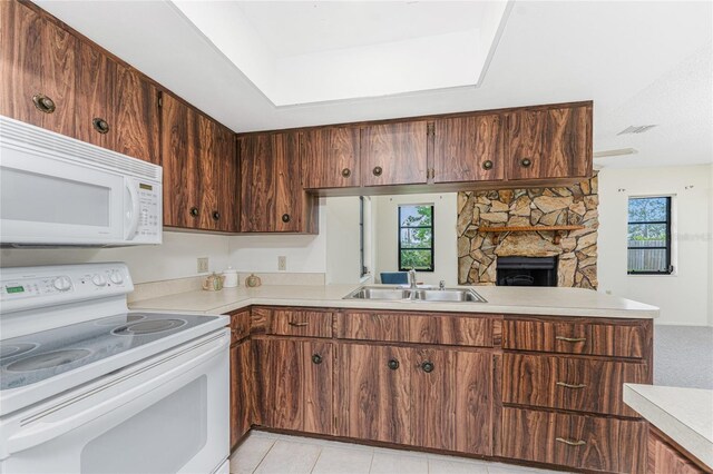 1337 Le Pera Rd, Englewood, FL 34223 - kitchen featuring white appliances, a sink, light countertops, a fireplace, and light tile patterned floors