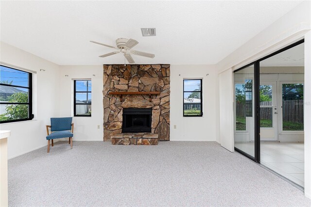 1337 Le Pera Rd, Englewood, FL 34223 - unfurnished living room featuring plenty of natural light, a ceiling fan, a fireplace, and carpet