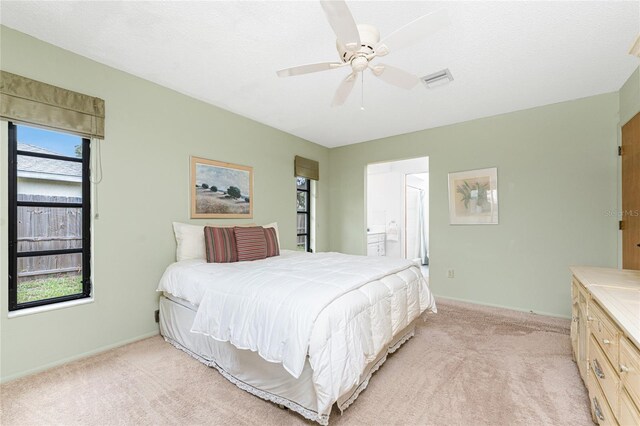 1337 Le Pera Rd, Englewood, FL 34223 - bedroom with light colored carpet, ensuite bath, baseboards, and a ceiling fan