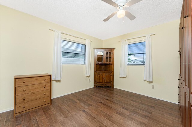 1337 Le Pera Rd, Englewood, FL 34223 - spare room featuring wood finished floors, ceiling fan, plenty of natural light, baseboards, and a textured ceiling
