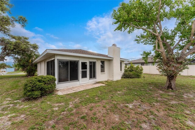 1337 Le Pera Rd, Englewood, FL 34223 - back of house with a chimney