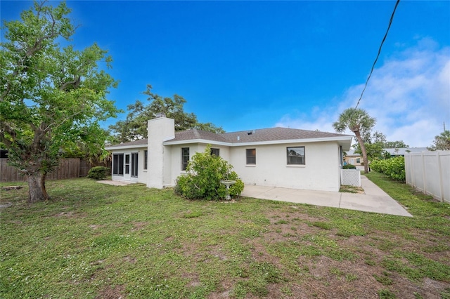 1337 Le Pera Rd, Englewood, FL 34223 - rear view of house featuring a chimney, a patio area, and stucco siding