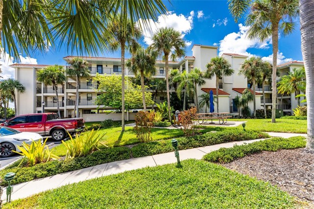 1591 Beach Rd Unit 402, Englewood, FL 34223 - view of apartment building / complex featuring uncovered parking