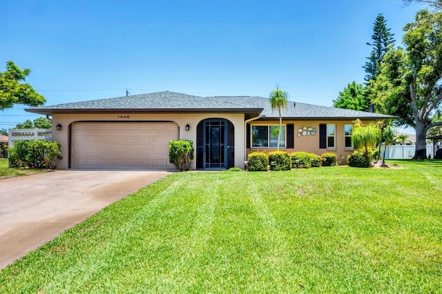 1040 Caples St, Englewood, FL 34223 - ranch-style home with stucco siding, a garage, a front yard, and concrete driveway