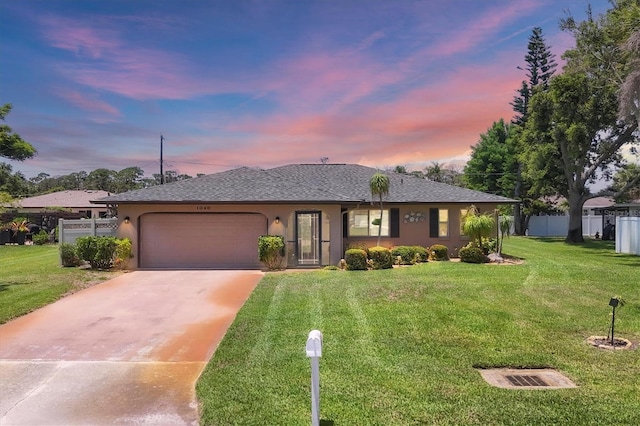 1040 Caples St, Englewood, FL 34223 - single story home featuring an attached garage, concrete driveway, stucco siding, and roof with shingles