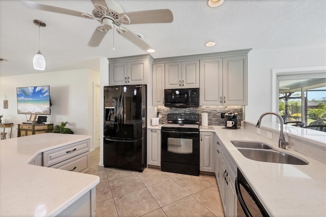1040 Caples St, Englewood, FL 34223 - kitchen with black appliances, a sink, decorative backsplash, ceiling fan, and light tile patterned flooring