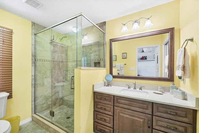 1040 Caples St, Englewood, FL 34223 - bathroom with toilet, vanity, a shower stall, and tile patterned floors
