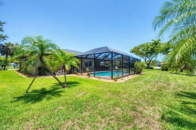 1040 Caples St, Englewood, FL 34223 - view of green lawn with glass enclosure and an outdoor pool