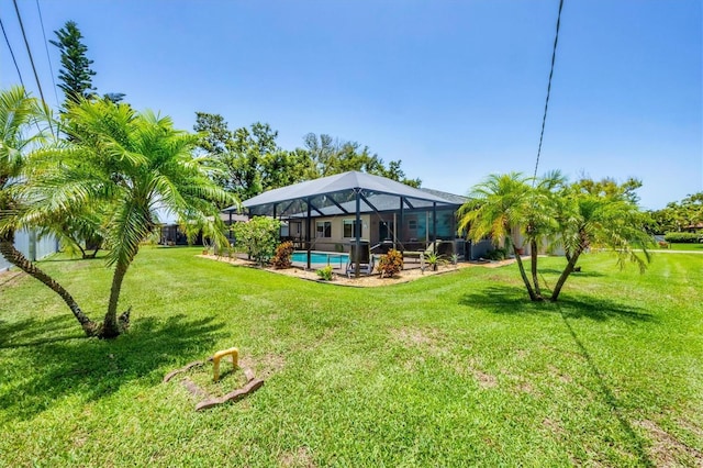 1040 Caples St, Englewood, FL 34223 - view of grassy yard with an outdoor pool and glass enclosure